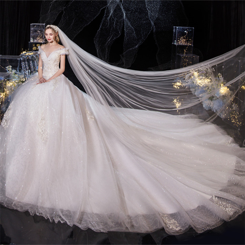 Beautiful big trailing flat shoulder wedding dress