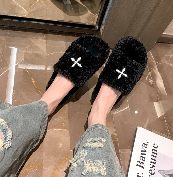 Lady wears outside flat elmo slippers for women