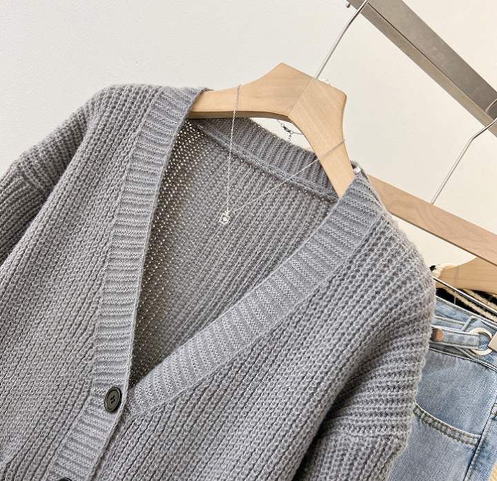 Gray spring knitted sweater wears outside V-neck tops