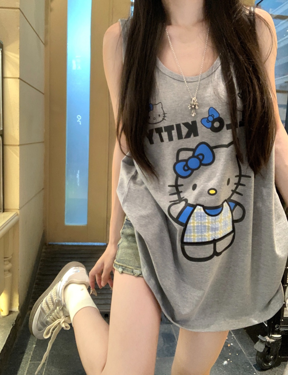 Gray sling tops wears outside cat vest for women