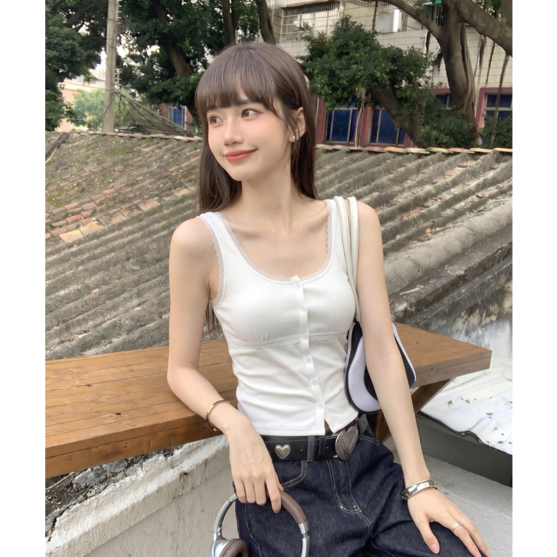 White lace vest wears outside sling cardigan