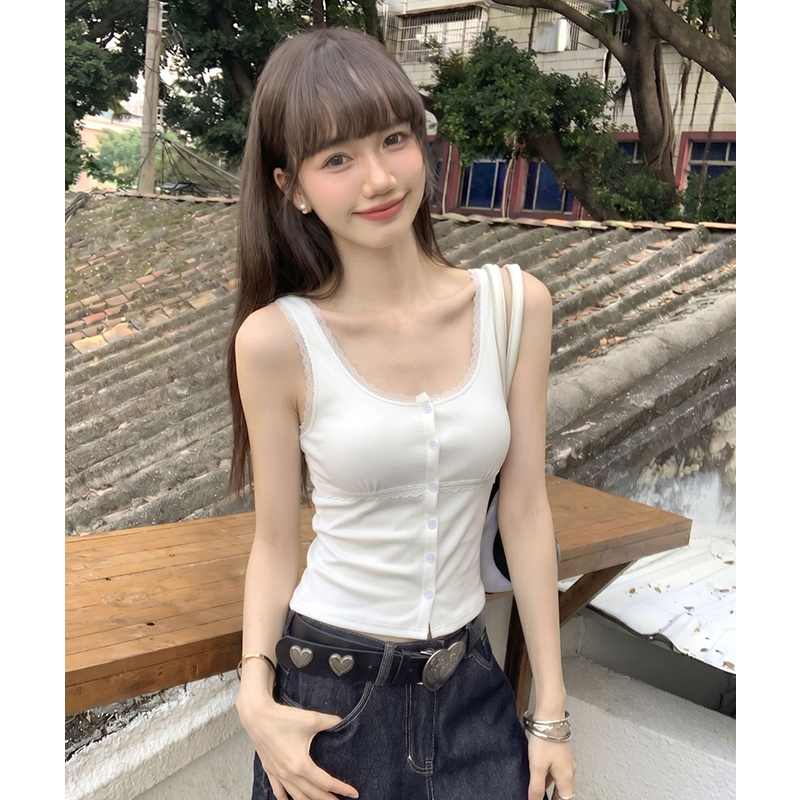 White lace vest wears outside sling cardigan
