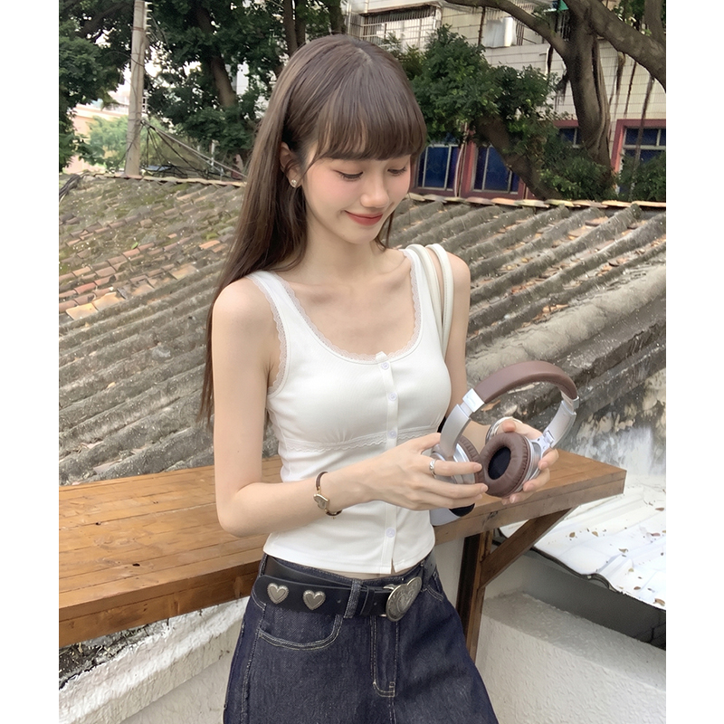 White lace vest wears outside sling cardigan